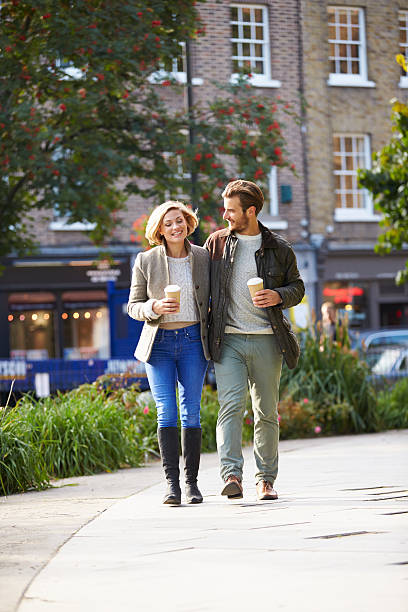 istock Couple Walking Through Park With Takeaway Coffee 471691762