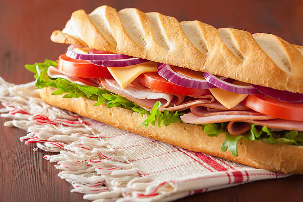 istock long baguette sandwich with ham cheese tomato lettuce 471692294