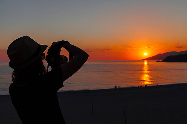 istock Young girl photographing the sunset 471692790