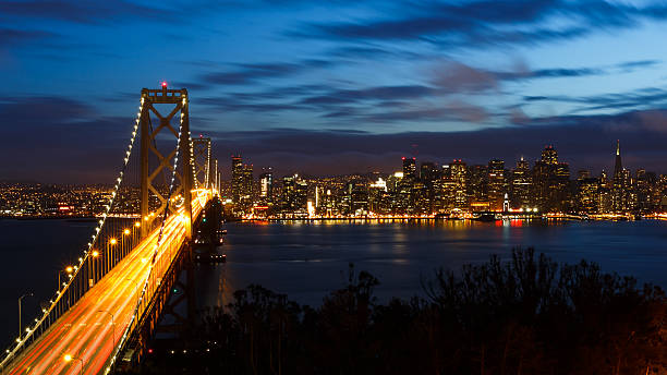 istock San Francisco Bay Bridge and skyline at night 471692832
