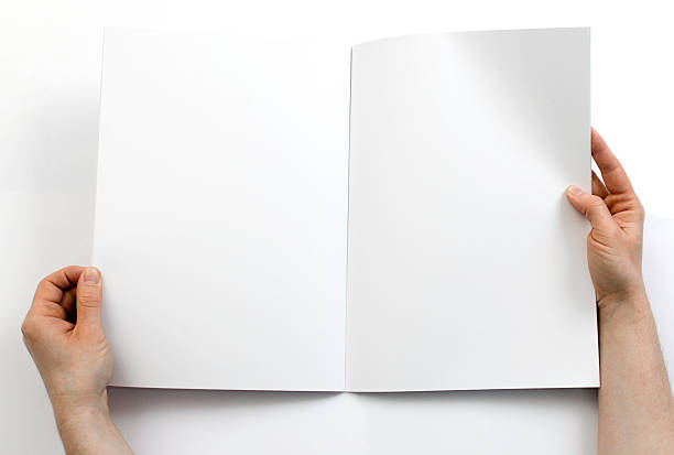 istock Reading a blank magazine in front of a white background 471692998