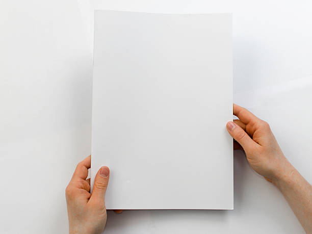 istock Holding a blank brochure in front of a white background 471693296