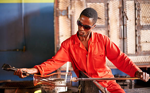 Shot of a glassblower shaping a glass product at his workbenchhttp://195.154.178.81/DATA/i_collage/pu/shoots/795699.jpg