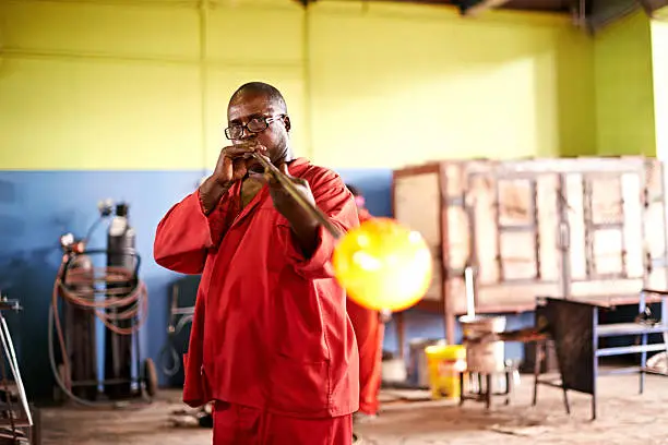 Shot of a glassblower shaping molten glass using a blowpipehttp://195.154.178.81/DATA/i_collage/pu/shoots/795699.jpg
