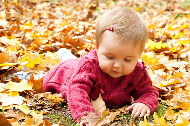 istock Happy baby playing with leaves 471694331