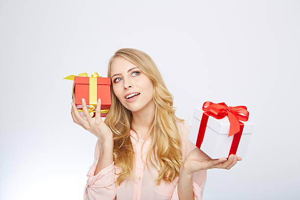 istock young blond woman with present box 471695130