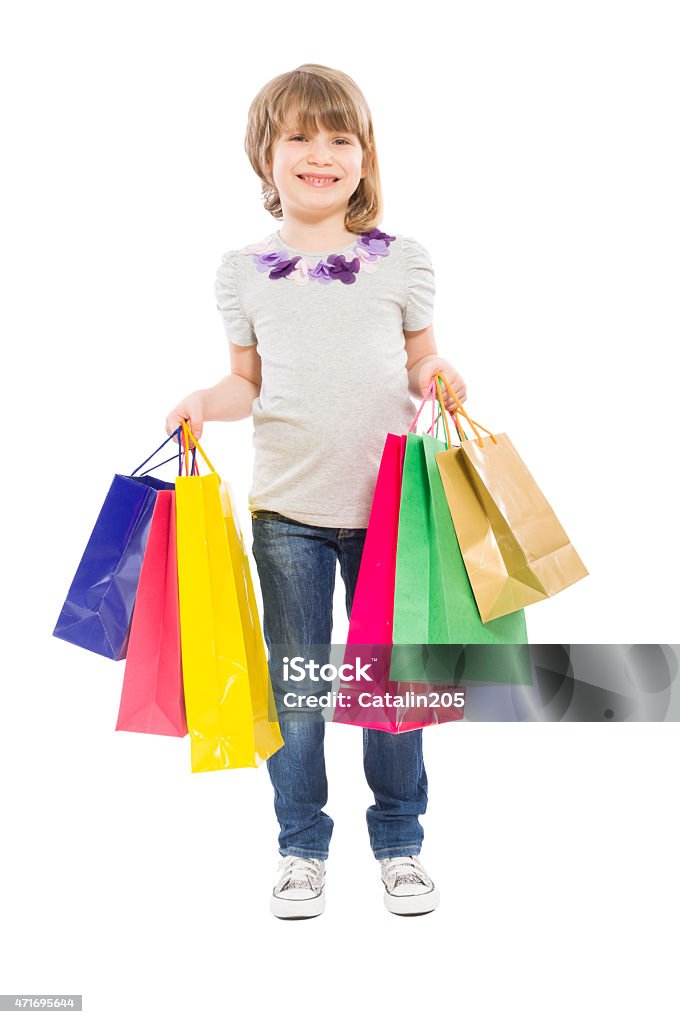 Young blonde girl holding shopping bags Young blonde girl holding shopping bags isolated on white background 2015 Stock Photo