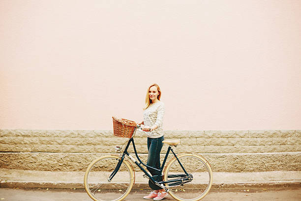 istock Young blonde woman on a vintage bicycle 471696012