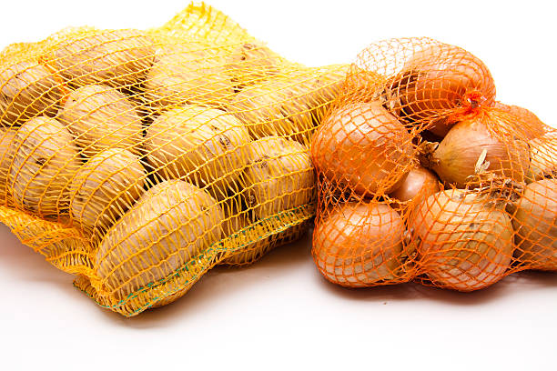 istock Potatoes and onions in the net 471696703