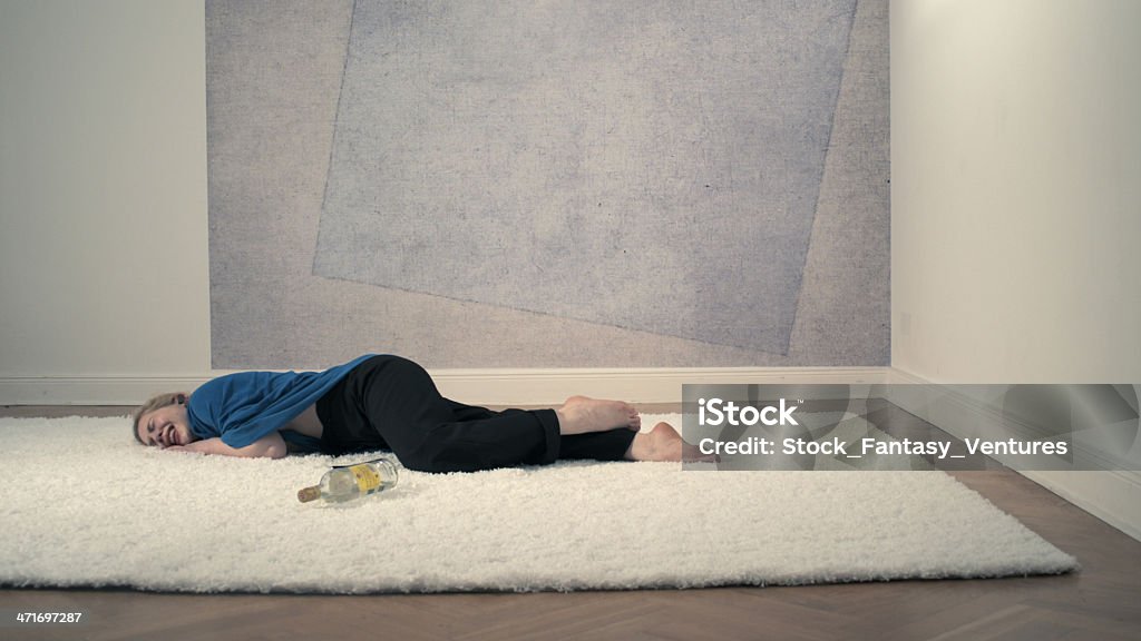 Sobbing Drunk CEO Sobbing drunk CEO on a thick fur rug wearing bluetooth device and wrapped in an airplane blanket 20-29 Years Stock Photo