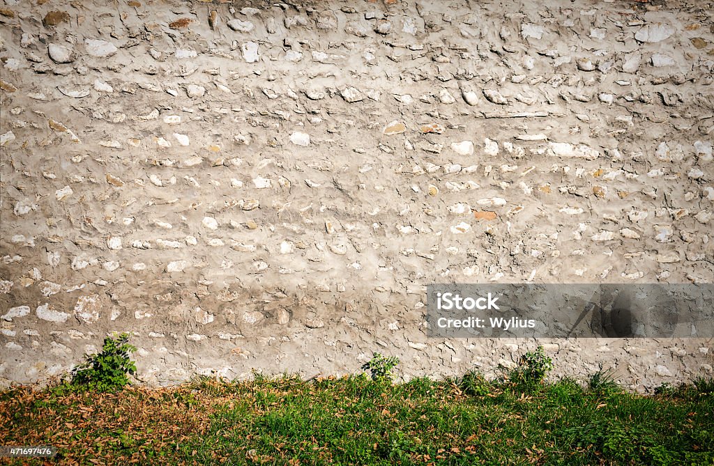Old stone wall Old weathered wall of stones and a ground 2015 Stock Photo