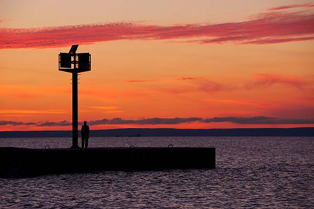 istock Person Standing on a Pier in Lake Superior 471697877
