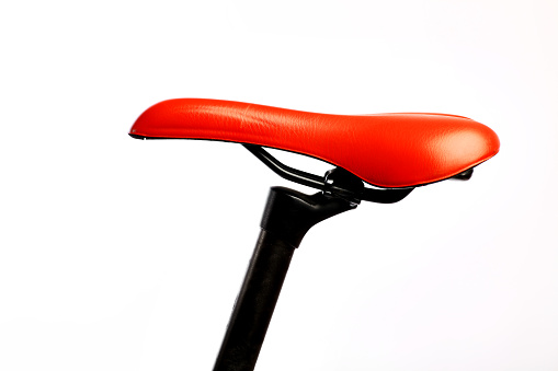 Color detail of the red saddle of a bicycle