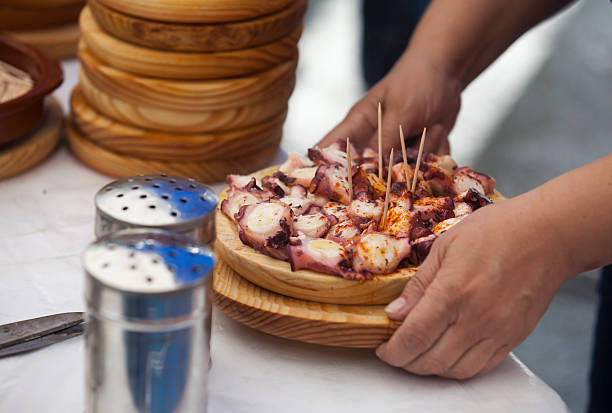 Serving Pulpo in Galicia Preparing and serving the famous dish Pulpo in Galicia galicia stock pictures, royalty-free photos & images