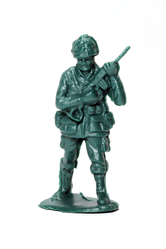 A green toy soldier against a white background.