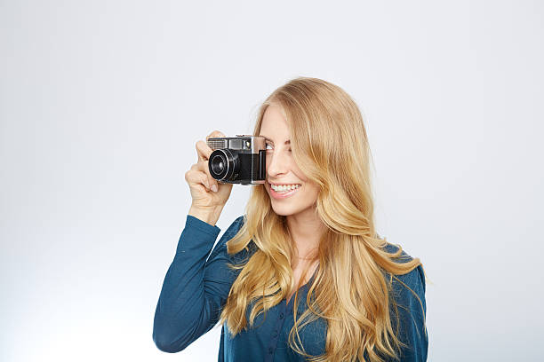 istock young blond woman with a vintage camera 471699614