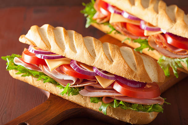 istock long baguette sandwich with ham cheese tomato lettuce 471699914