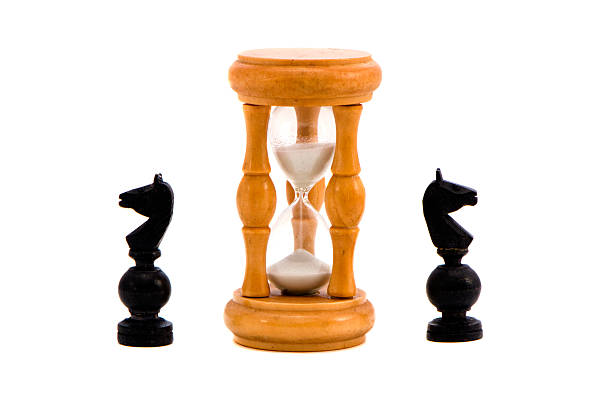 istock isolated sandglass and two black knigts 471699995
