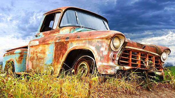 Picturesque rural  landscape with old abandoned vintage car.