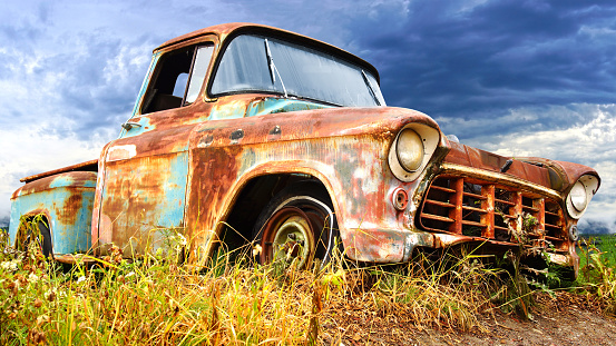 Picturesque rural  landscape with old abandoned vintage car.