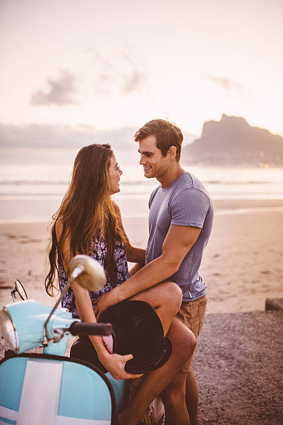 istock Affectionate couple and their scooter at the beach 471700494