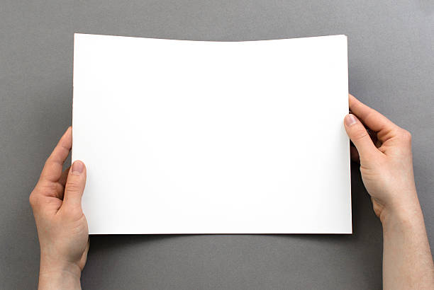istock Hands holding a blank brochure from above with copy space 471700800