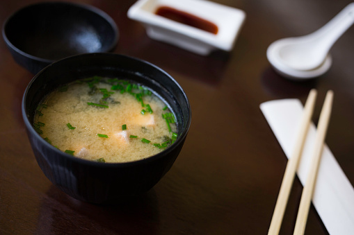 japanese soup with spoon and chopstick on a table at a restaurant