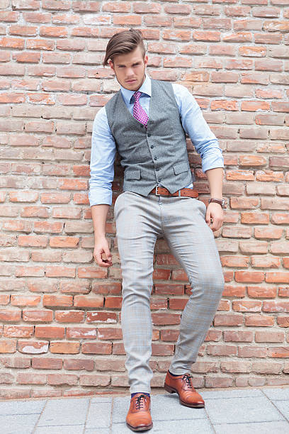istock casual man leans on a brick wall with his back 471701281
