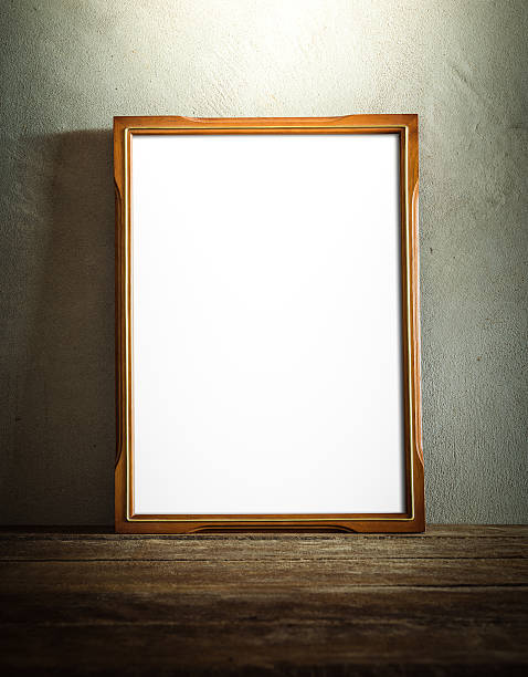 istock Blank wooden photo frame propped against grunge style wall 471701708