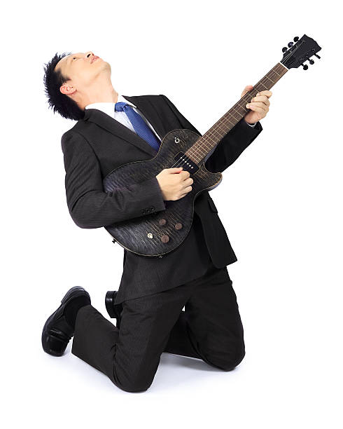 istock Asian man with a black electric guitar 471701999