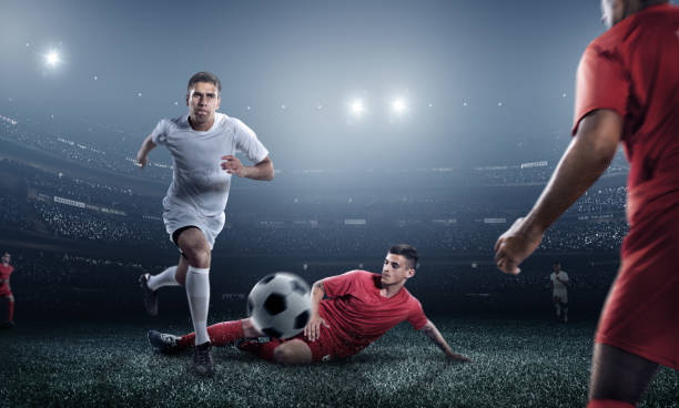 istock Soccer player kicking ball in stadium 471702046