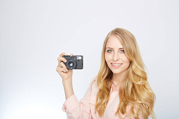 istock young blond woman with a vintage camera 471702184