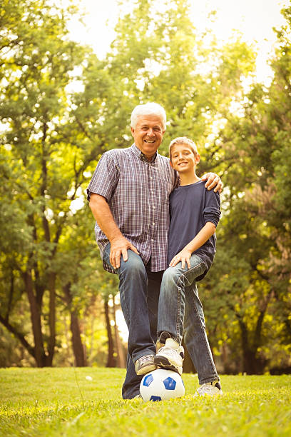 istock Grandfather and grandson playing in the park 471702467
