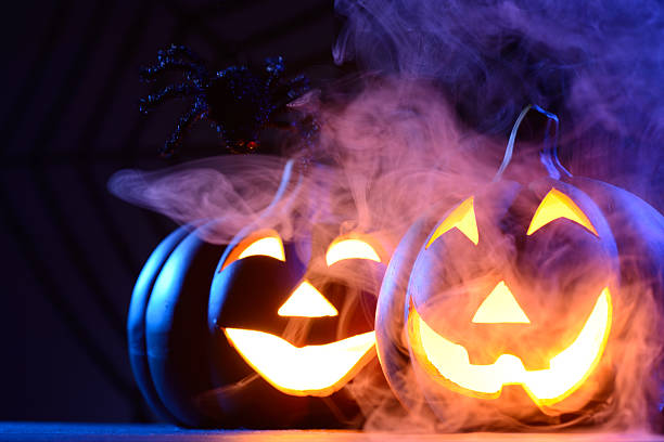 istock Halloween pumpkin in dark blue with spider web and smoke 471702503