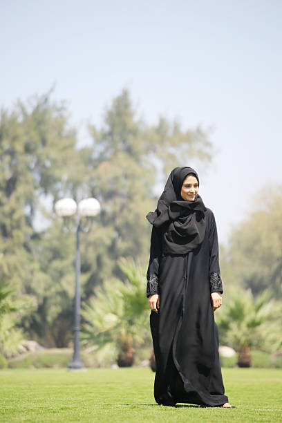 istock Arab woman standing on green grasses 471702778