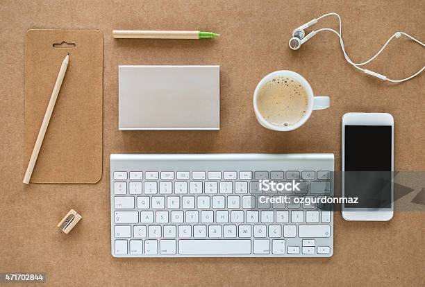 Working Desk With Keyboard Coffee Cell Phone And Headphones Stock Photo - Download Image Now