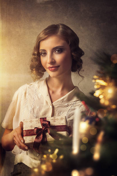 istock retro girl holding christmas gift 471703015