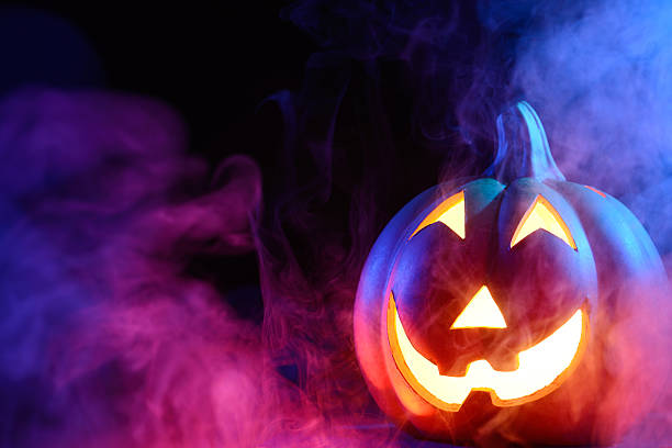 istock Halloween pumpkin with colorful smoke 471703509