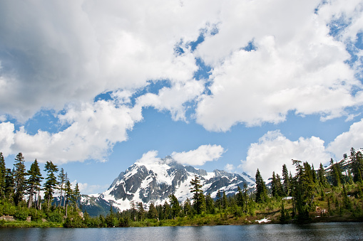 The North Cascades is a vast wilderness of conifer-clad mountains, glaciers and lakes. It is one of the more remote wilderness areas in the Continental United States. Because of its striking beauty, Mount Shuksan in the North Cascades, is one of the most photographed mountains in the world. This picture of Mount Shuksan was taken from Picture Lake in the Mount Baker National Forest in Washington State, USA.