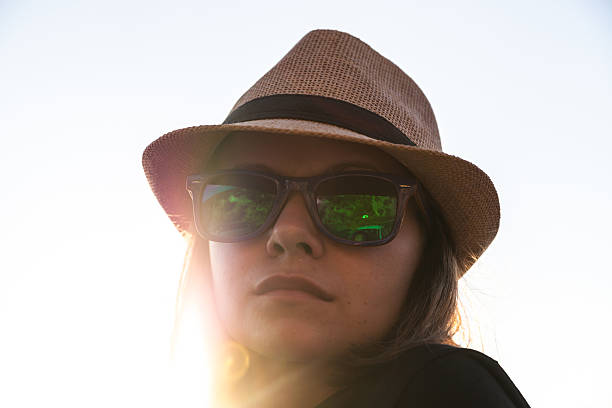 istock Young woman in a hat and sunglasses 471704164