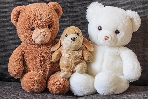 istock Cute old teddy bears and dog on couch 471704381