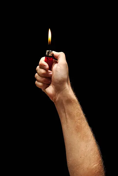 Photo of Man hand holding burning lighter