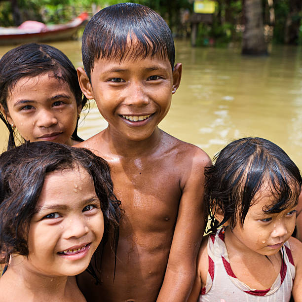 istock Children having fun in the water during flood, Cambodia 471705321