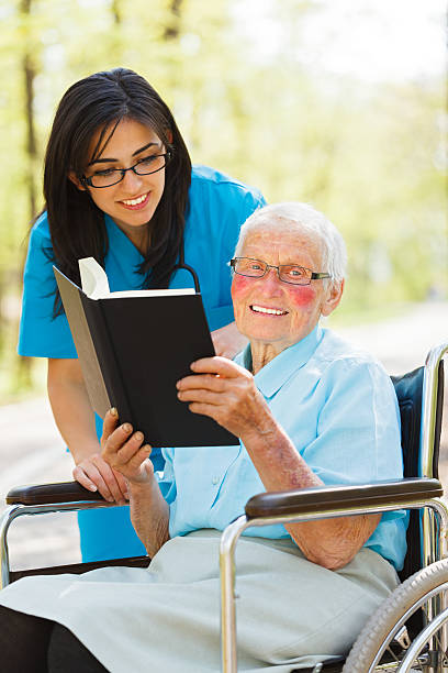 istock Elderly Lady in Wheelchair Reading 471705683