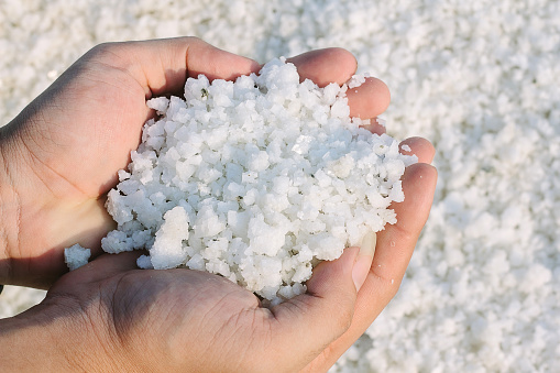 salt crystal on hands in salt field