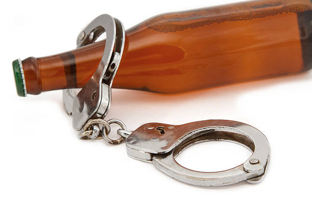 istock bottle beer and handcuffs,Drunk driving concept 471706541