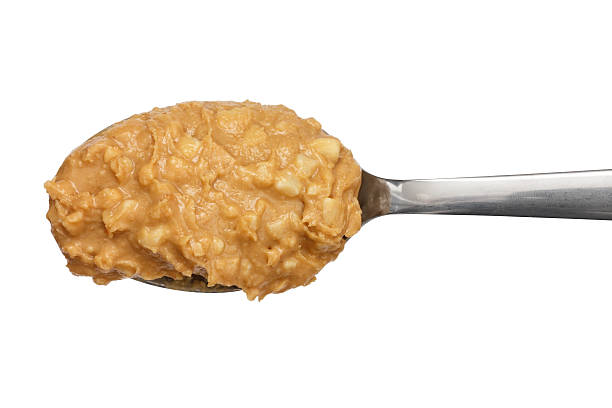 istock Crunchy peanut butter on metal spoon. 471706834
