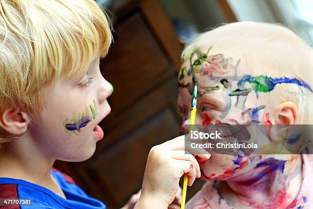 Child Painting His Baby Brothers Face Stock Photo - Download Image Now - Child, Mischief, Messy
