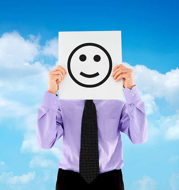 istock Businessman holding smiling emoticon 471707517