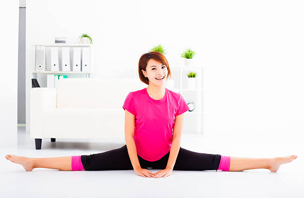 istock beautiful young woman stretching on the floor 471708336